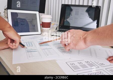 Designers discussing interface layouts Stock Photo