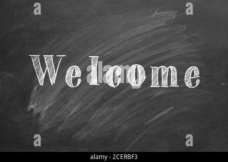 Hand drawing  text 'WELCOME' on blackboard. Stock Photo