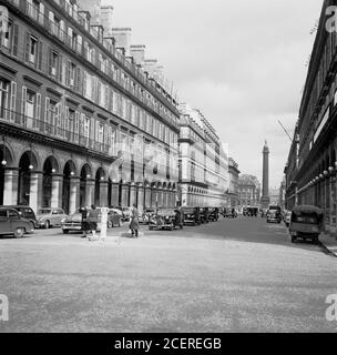 1950s, historical view of Rue Saint-Honore and surrounding buildings including the Hotel Lotti in Paris, France. The hotel was funded in 1910 by the Duke of Westminster and was located in an old Jacobin convent, becoming popular wth aristocrats and the bourgeois, who christened it 'the smallest of grand hotels'. Stock Photo