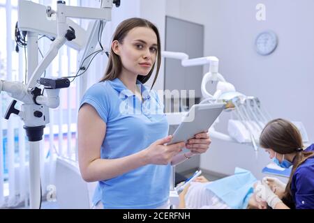 Portrait of dentist doctor with digital tablet Stock Photo
