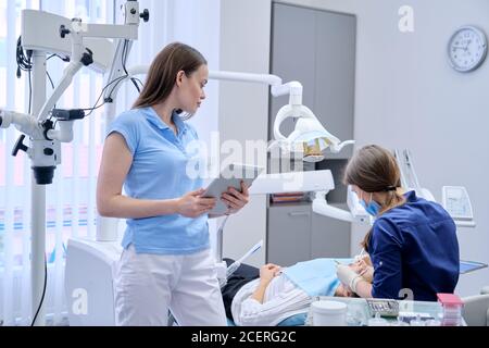Portrait of dentist doctor with digital tablet Stock Photo