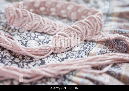 Handmade macrame dress belt. Natural cotton threads and wooden beads. Stylish decoration for women 's dress.  Macrame braiding and cotton threads. Fem Stock Photo