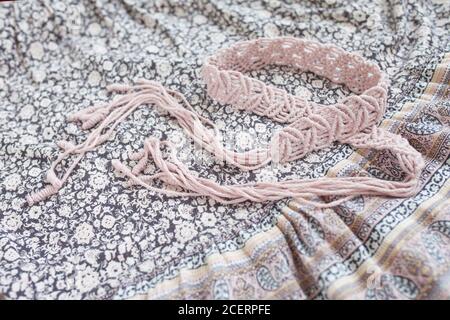 Handmade macrame dress belt. Natural cotton threads and wooden beads. Stylish decoration for women 's dress.  Macrame braiding and cotton threads. Fem Stock Photo