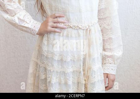 Handmade macrame dress belt. Natural cotton threads and wooden beads. Stylish decoration for women 's dress.  Macrame braiding and cotton threads. Fem Stock Photo