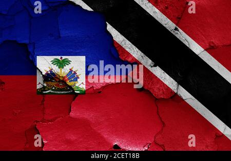 flags of Haiti and Trinidad and Tobago painted on cracked wall Stock Photo