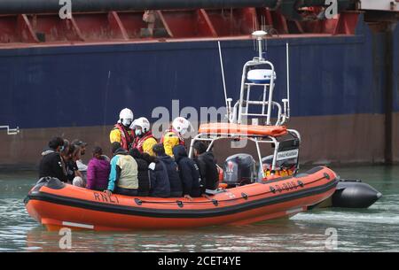 A group of people thought to be migrants are brought into Dover, Kent, by the RNLI following a small boat incident in the Channel. Stock Photo