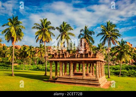 hampi ruins ancient breathtaking stone art with bright blue sky flat angle shot image is taken at hampi karnataka india. it is showing the impressive Stock Photo