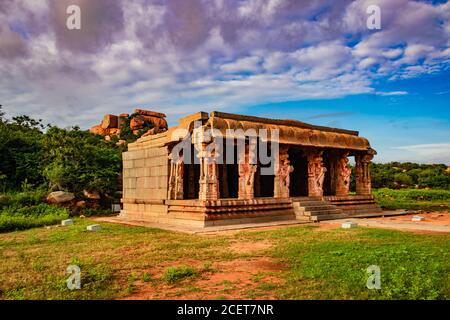 hampi ruins ancient breathtaking stone art with bright blue sky flat angle shot image is taken at hampi karnataka india. it is showing the impressive Stock Photo