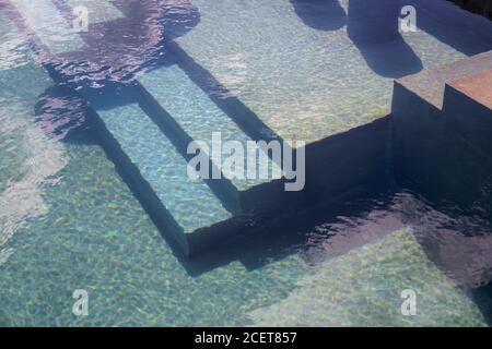 Swimming pool view, detail of the stairs going into the water Stock Photo