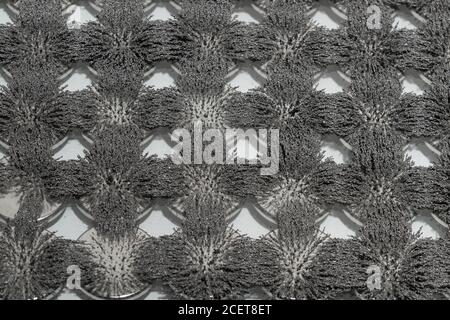 Invisible magnetic flux made visible with iron filings creating interesting  interlocking patterns with circular magnet Stock Photo