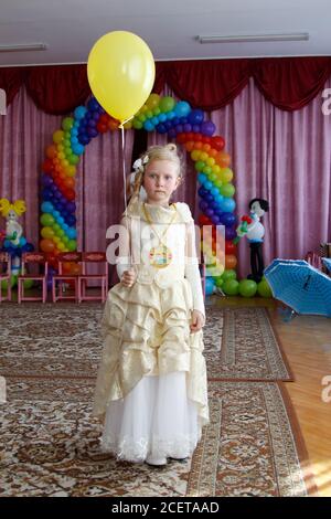 Belarus, the city of Gomil, May 26, 2016. Photo session in kindergarten.Girl preschooler with a balloon at the graduation party in kindergarten. Stock Photo