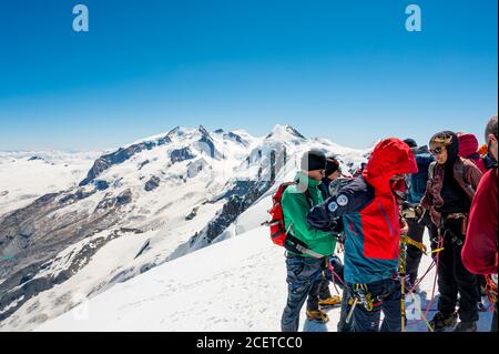 Cervinia, Italy - July 18, 2020: Mountaineers ascending and tackling slopes of Breithorn - considered to be the easiest 4000m peak in Alps Stock Photo