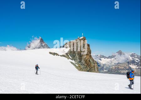 Cervinia, Italy - July 18, 2020: Mountaineers ascending and tackling slopes of Breithorn - considered to be the easiest 4000m peak in Alps Stock Photo