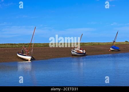 Boats at low tide at Burnham-Overy-Staithe on the Norfolk coast, UK Stock Photo