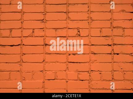 Orange bricks background. Painted brick wall. Orange brick wall background. Big full frame background of detailed old red brick wall with copy space. Stock Photo