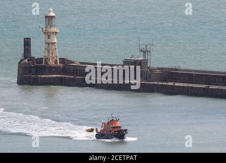A group of people thought to be migrants are brought into Dover, Kent, by the RNLI following a small boat incident in the Channel. Stock Photo