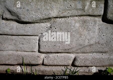 Texture of a stone wall. A plastered wall with different stone sizes. Stock Photo
