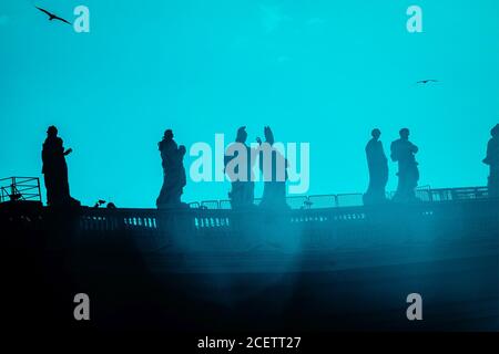 Sculptures of saints in Vatican, black silhouette on aquamarine background Stock Photo