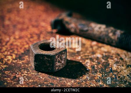 closeup of a rusty nut and a rusty bolt, on a rusty surface Stock Photo