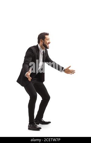 Happy young man in a suit gesturing with hands isolated on white background Stock Photo