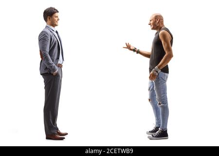 Full length profile shot of a man in a suit and a hipster guy having a conversation isolated on white background Stock Photo