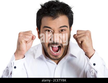 Portrait of an angry man with hands in air, wide open mouth yelling, isolated white background. Negative emotion, facial expression feelings. Stock Photo