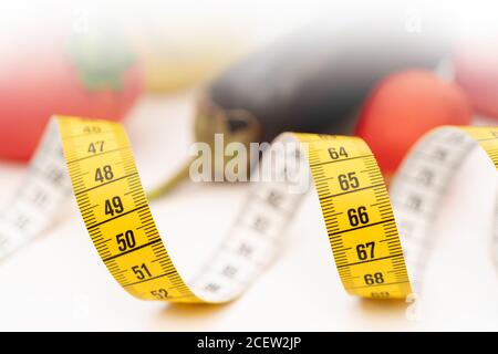 Yellow measuring tape. Fresh vegetables for healthy lifestyle diet food. Stock Photo