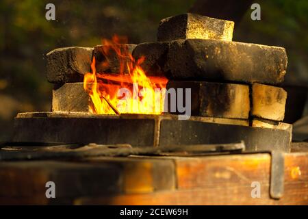a burning forge made of bricks in nature Stock Photo