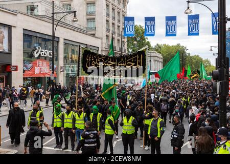 Crowd marching on Oxford Street during Ashura Day event for Shia Muslims, London, 30 August 2020 Stock Photo