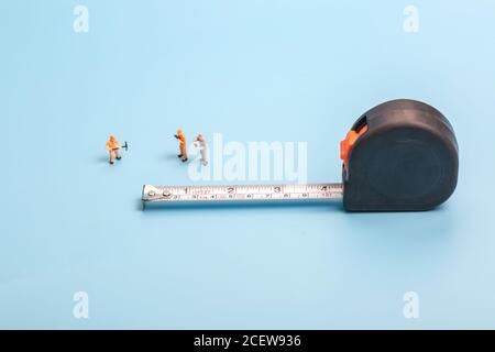 Meter stick and worker on blue background