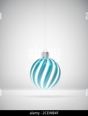 Glossy glass blue and white twisted striped Christmas ball over white background. Christmas decoration, festive atmosphere concept. Stock Photo