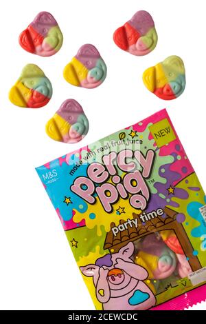 Bag of new Marks & Spencer percy pig party time sweets opened with contents spilled spilt set on white background made with real fruit juice Stock Photo