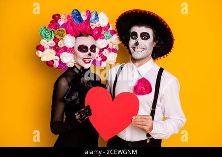 Portrait of his he her she nice glamorous cheerful glad couple embracing holding in hands red heart paper card cupid feelings isolated bright vivid Stock Photo