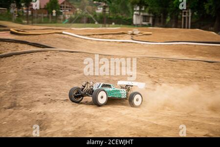 Offroad RC buggy driving on an outdoor dirt track Stock Photo