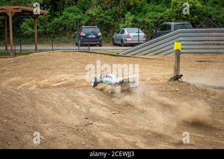 Offroad RC buggy driving on an outdoor dirt track Stock Photo