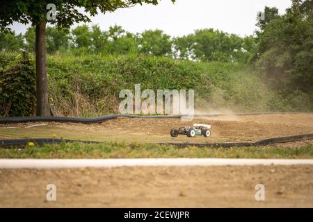 Offroad RC buggy driving on an outdoor dirt track Stock Photo