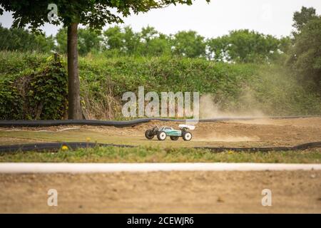 Offroad RC buggy driving on an outdoor dirt track Stock Photo