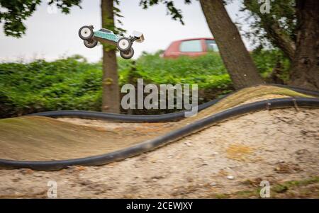 Offroad RC buggy driving on an outdoor dirt track Stock Photo