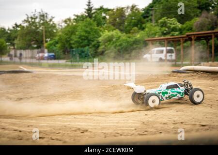 Offroad RC buggy driving on an outdoor dirt track Stock Photo