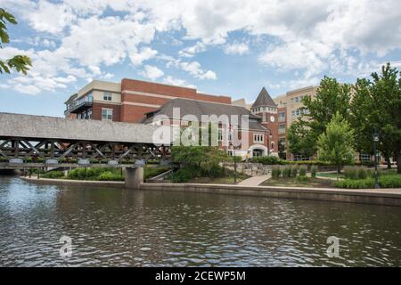 Naperville, Illinois, United States-April 24, 2014: Downtown architecture with riverwalk path and covered bridge in Naperville, Illinois Stock Photo