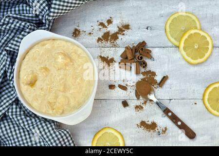 rice pudding and cinnamon with lemon slices on a wooden table Stock Photo