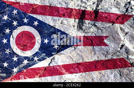 Only the Ohio national flag is non-rectangular and has rules for correct folding for conservation. Drawn on a rocky mountain wall for independence day Stock Photo
