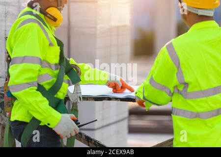 Asian engineers and workers consulted together for construction planning and development, Concept of construction team work. Stock Photo