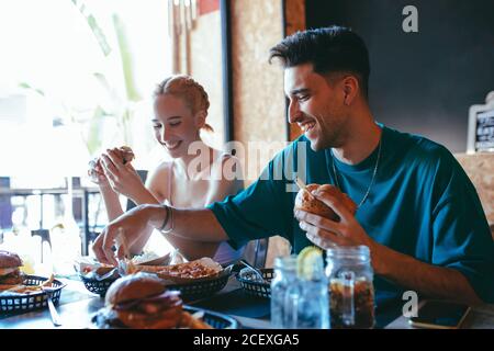 Cheerful friends having fun in fast food cafe Stock Photo