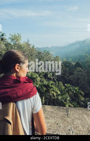 Young girl staying on the rock and looking on mountains landscap Stock  Photo by ©Yanapoles 119039098