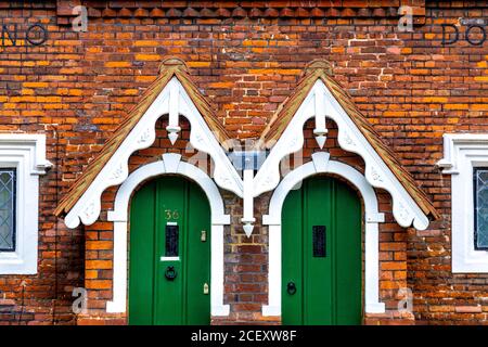 Almhouses, chrming cottages with green doors in Baldock, UK Stock Photo