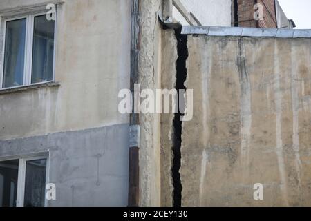 Bucharest, Romania - September 2, 2020: Big structural crack on an old inhabited building in Old Town Bucharest. Stock Photo