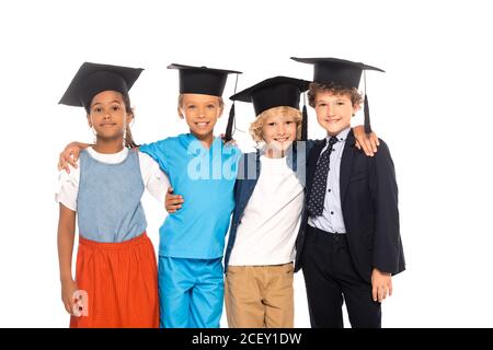 multicultural children in graduation caps dressed in costumes of different professions isolated on white Stock Photo