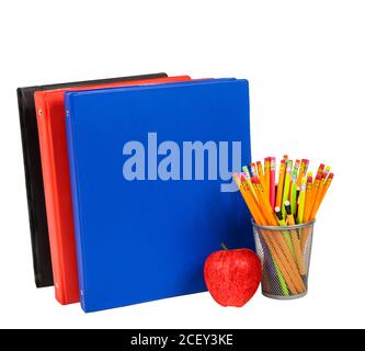 Horizontal shot of colorful notebooks, pencils and a red apple isolated on white background. Stock Photo