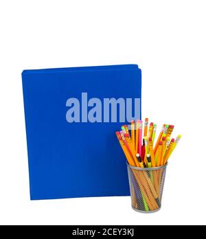Blue notebook with lots of copy space and colorful pencils in a pencil holder. Isolated on white. Stock Photo